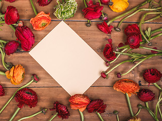 Image showing Ranunkulyus bouquet of red flowers on a wooden background