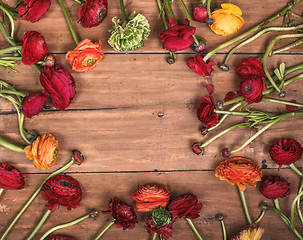 Image showing Ranunkulyus bouquet of red flowers on a wooden background