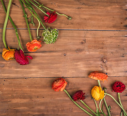 Image showing Ranunkulyus bouquet of red flowers on a wooden background