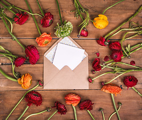 Image showing Ranunkulyus bouquet of red flowers on a wooden background