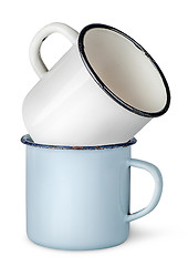 Image showing Two old enameled mugs on each other