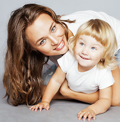 Image showing mother with daughter together in bed smiling, happy family close up, lifestyle people concept, cool real modern family 