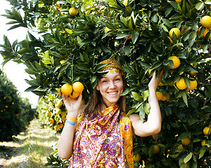 Image showing pretty islam woman in orange grove smiling