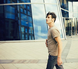 Image showing real young man stand in front of modern business building