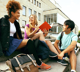 Image showing cute group of teenages at the building of university with books 