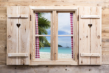 Image showing Wooden window with sunny beach panorama view