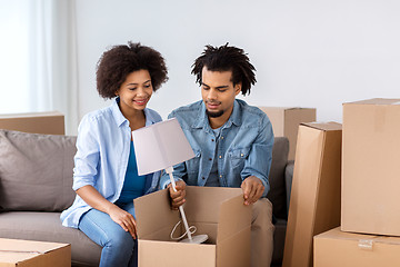 Image showing happy couple with stuff moving to new home