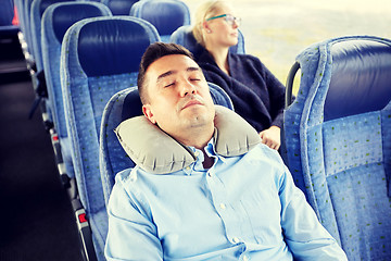 Image showing man sleeping in travel bus with cervical pillow