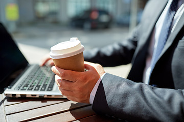 Image showing senior businessman with laptop and coffee outdoors