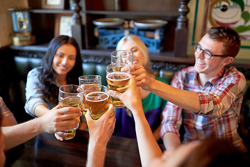 Image showing happy friends drinking beer at bar or pub