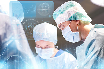 Image showing group of surgeons in operating room at hospital