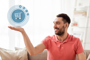 Image showing man with shopping cart icon projection at home