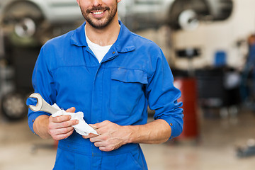 Image showing auto mechanic or smith with wrench at car workshop