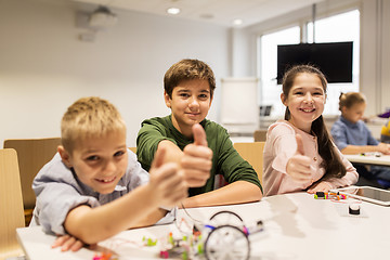 Image showing happy children building robots at robotics school