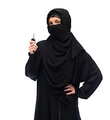 Image showing muslim woman in hijab with car key over white