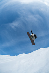 Image showing Snowboarder jumping against blue sky