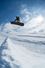 Image showing Snowboarder jumping against blue sky