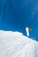 Image showing Snowboarder jumping against blue sky