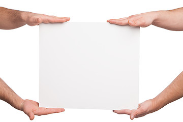 Image showing four hands holding a blank white board