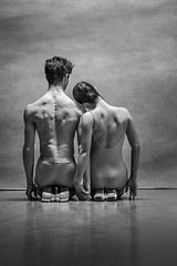 Image showing Couple of ballet dancers posing over gray background