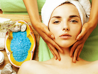 Image showing stock photo attractive lady getting spa treatment in salon, close up asian tan hands on face