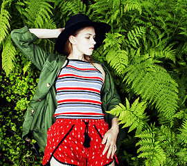 Image showing Pretty young blond girl hipster in hat among fern, vacation in g