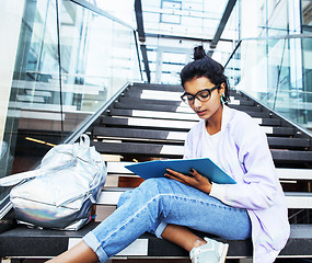 Image showing young cute indian girl at university building sitting on stairs 