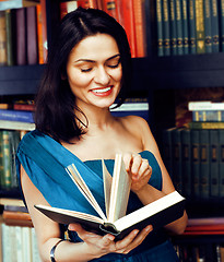 Image showing young teen brunette muslim girl in library among books emotional close up bookwarm, lifestyle smiling people concept 