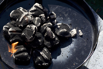 Image showing charcoal briquettes in small bbq