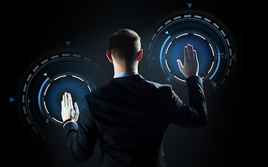 Image showing businessman touching virtual screen