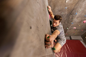 Image showing young man exercising at indoor climbing gym