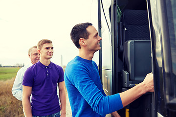 Image showing group of happy male passengers boarding travel bus