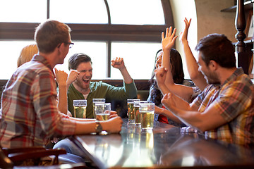 Image showing football fans or friends with beer at sport bar