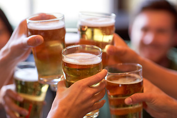 Image showing happy friends drinking beer at bar or pub