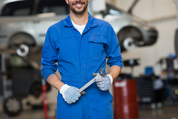 Image showing auto mechanic or smith with wrench at car workshop