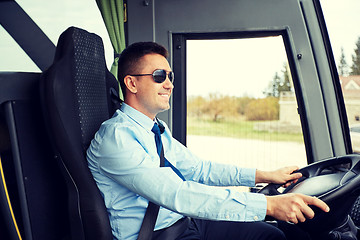 Image showing happy driver driving intercity bus