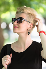 Image showing young woman with short blond hair and sunglasses