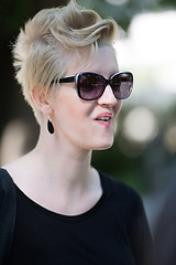 Image showing young woman with short blond hair and sunglasses