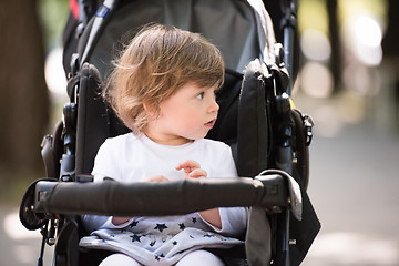 Image showing baby girl sitting in the pram