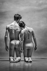 Image showing Couple of ballet dancers posing over gray background