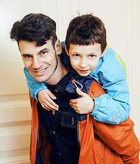 Image showing young handsome father with his son fooling around at home, lifes