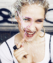 Image showing young pretty party girl smiling covered with glitter tinsel, fas