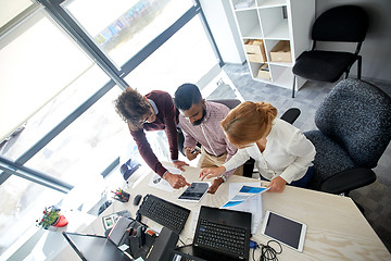 Image showing business team with tablet pc and papers at office