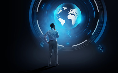 Image showing businessman looking at virtual earth projection