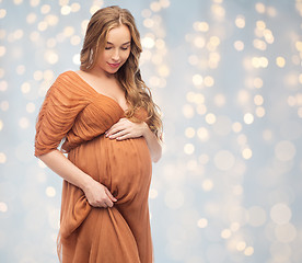 Image showing happy pregnant woman touching her big belly