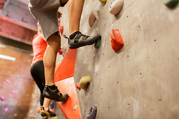 Image showing man and woman exercising at indoor climbing gym