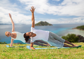 Image showing couple doing yoga exercise outdoors