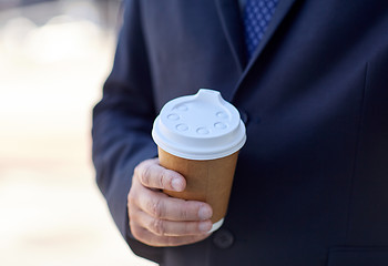 Image showing senior businessman with coffee cup outdoors