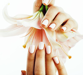 Image showing beauty delicate hands with manicure holding flower lily close up isolated on white