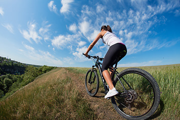 Image showing Mountain biking happy sportive girl relax in meadows sunny countryside